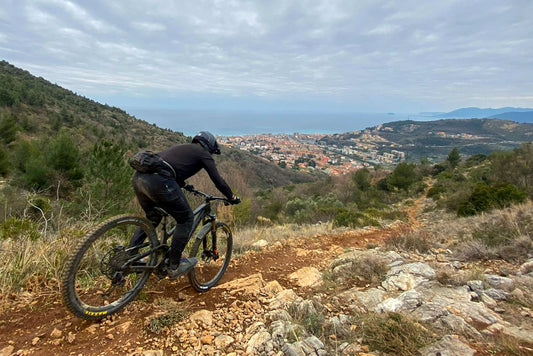 Mountainbiker riding towards Pietra Ligure