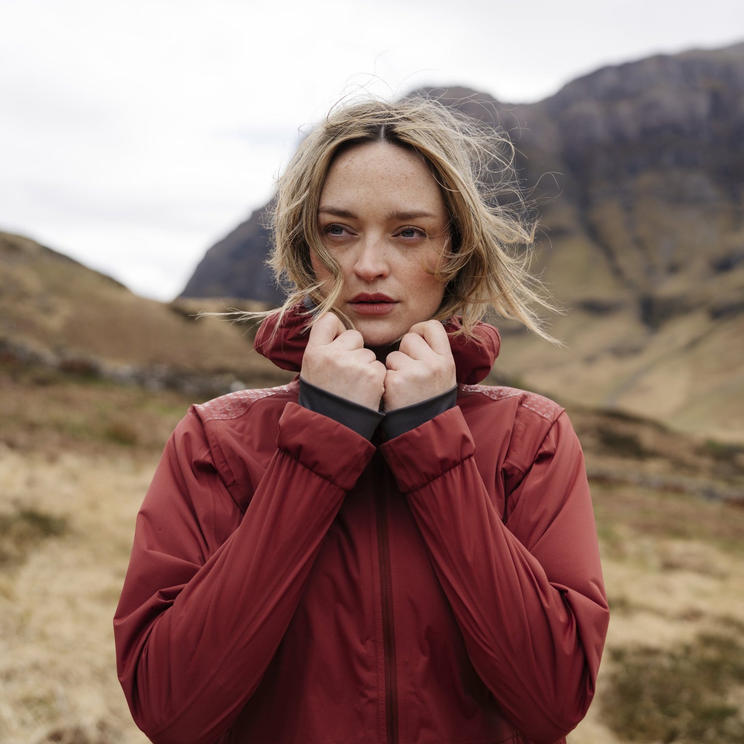 Woman wearing FINDRAStroma Waterproof lightweight jacket and accessories from the FINDRA Favourites collection while hiking outdoors