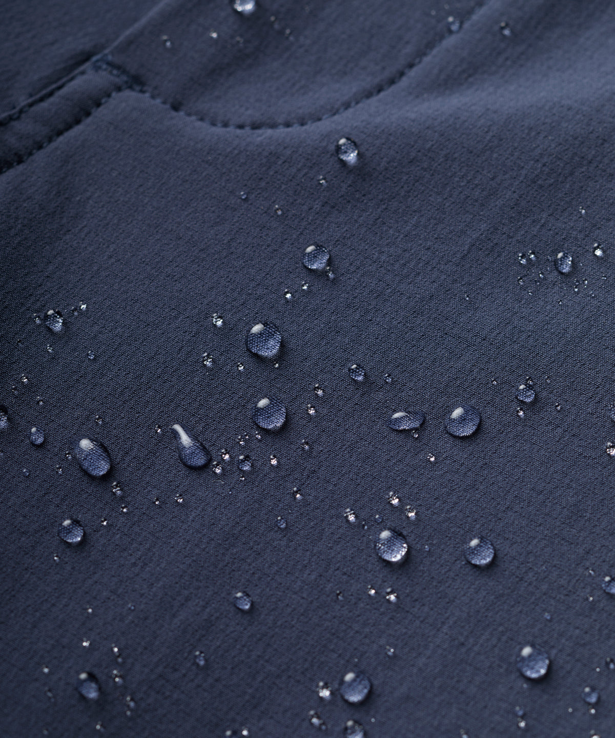 A close up of FINDRA's technical women's walking trousers showing the water repellent finish