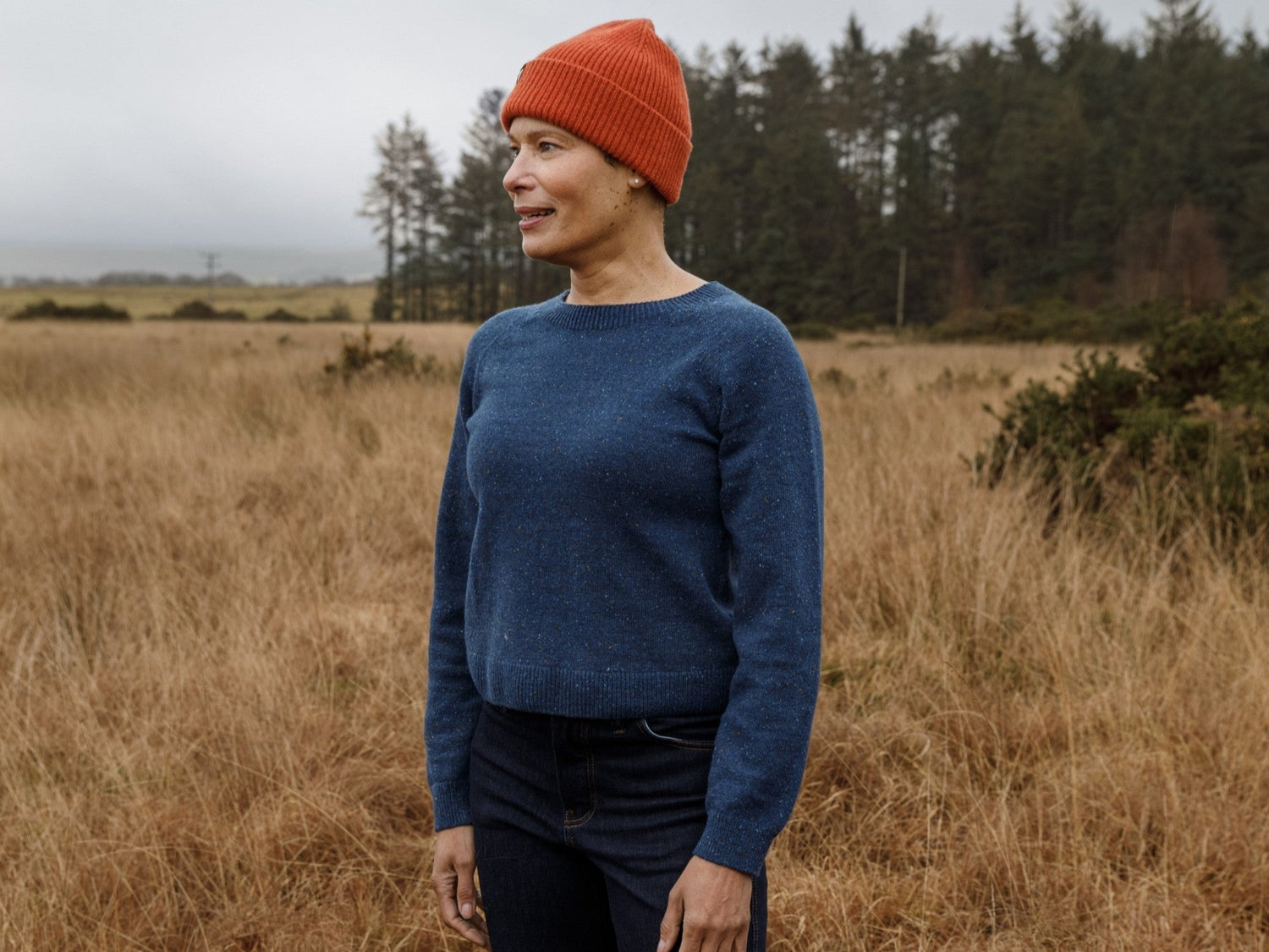 Image of a woman in the outdoors wearing FINDRA Merino Knitted Sweater and beanie