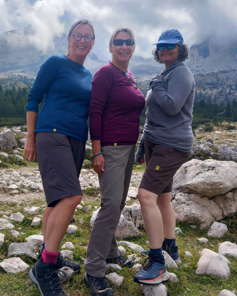 Three people posing for a photo in a mountainous landscape wearing all FINDRA gear