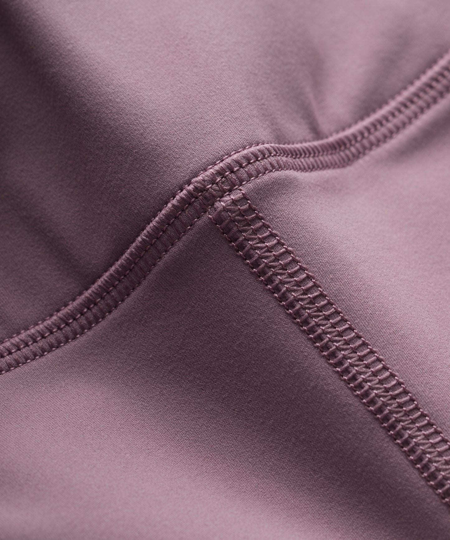 Close-up of a purple fabric with flat lock seam detail