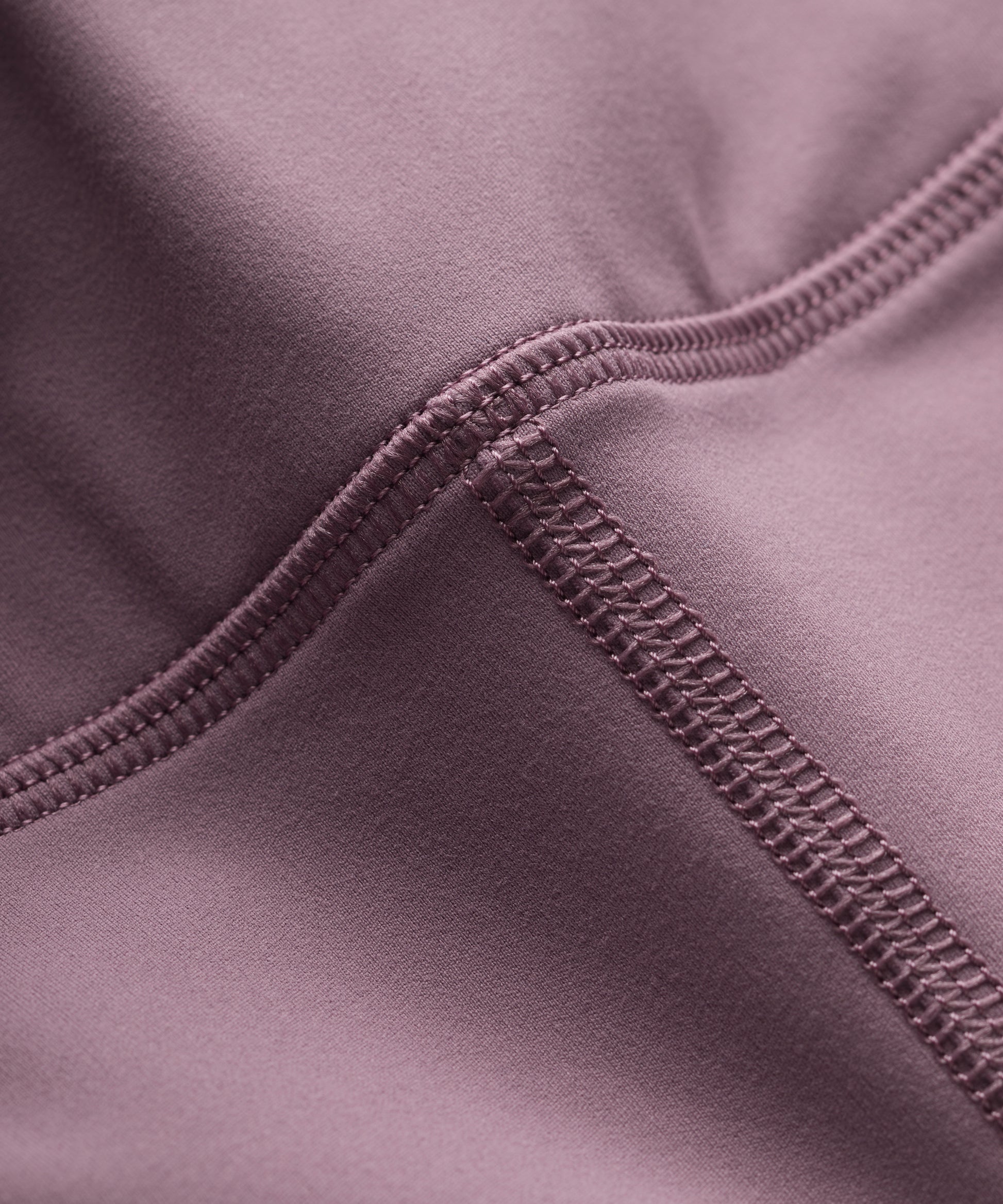 Close-up of a purple fabric with flat lock seam detail