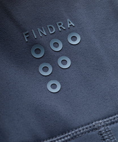 Close-up of a dark blue fabric with 'FINDRA' branding and circular elements.