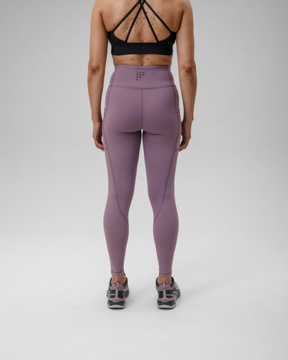 Person wearing purple FINDRA  leggings and black sports bra on a white background
