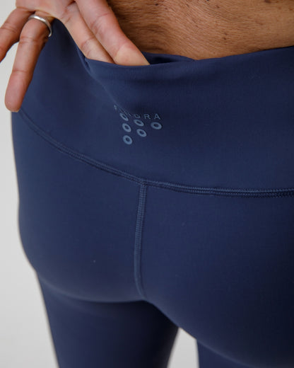 Navy leggings with a brand logo showing a pocket on the rear waistband
