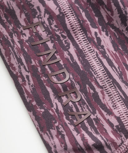 Close-up of purple patterned technical leggings with flatlocked seams and 'FINDRA' branding.