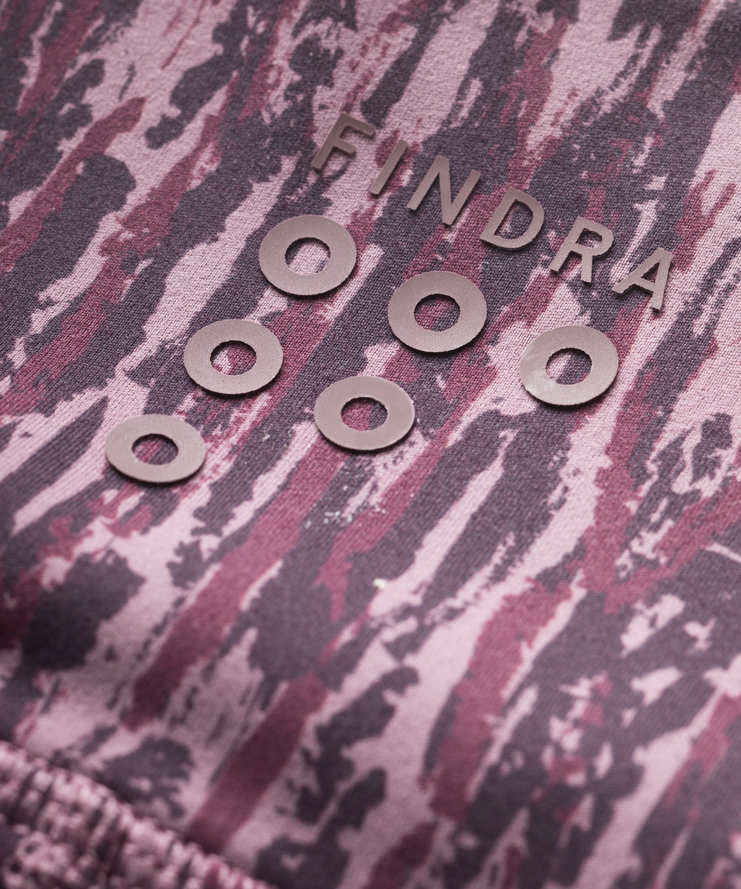 Purple patterned technical leggings close up showing FINDRA logo