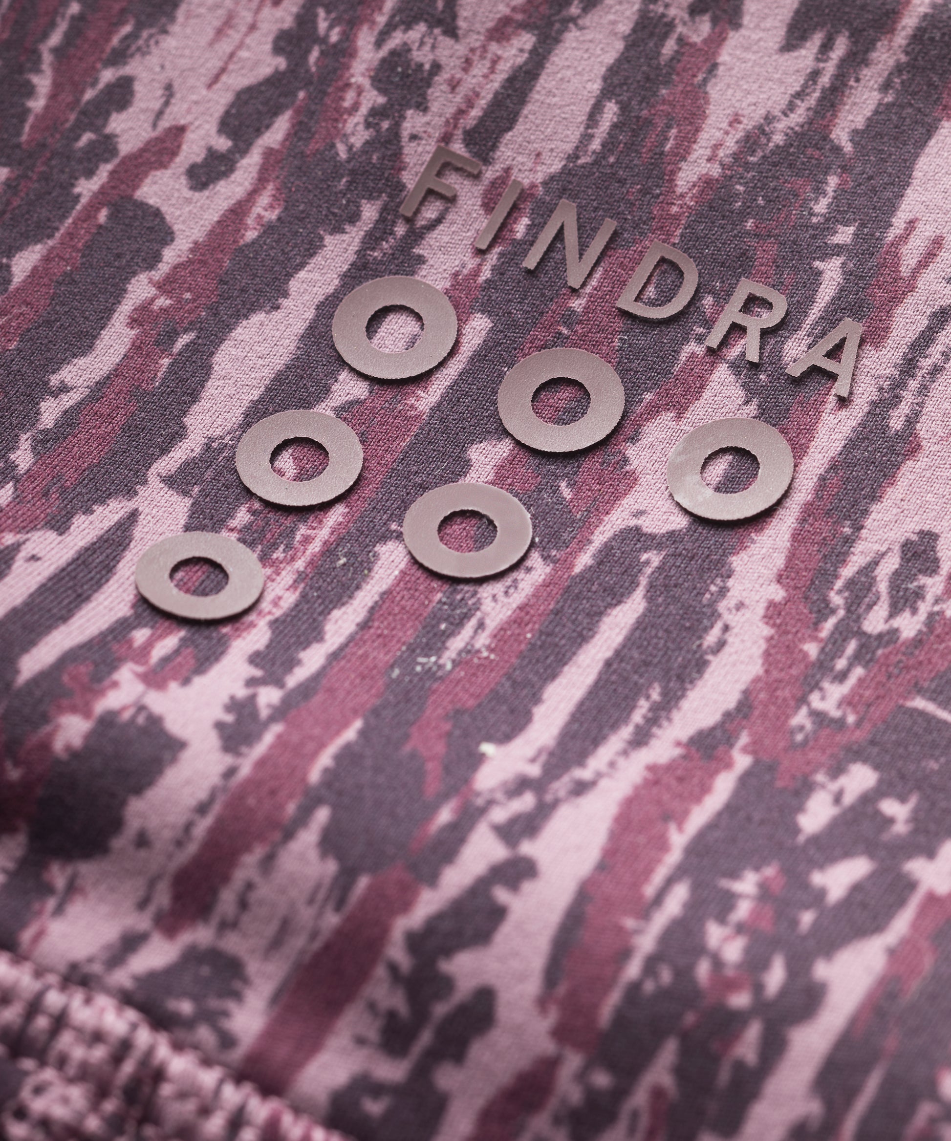 Purple patterned technical leggings close up showing FINDRA logo