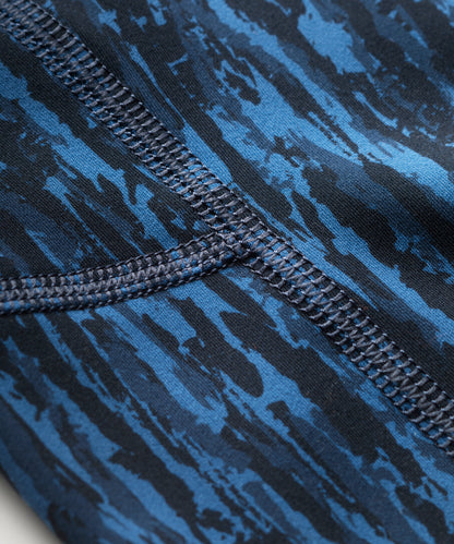 Close-up of a blue patterned leggings  with flatlocked seam detail.