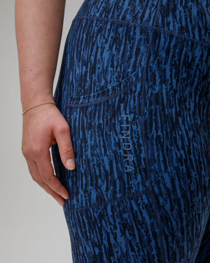 Blue patterned leggings with a FINDRA logo on a plain background