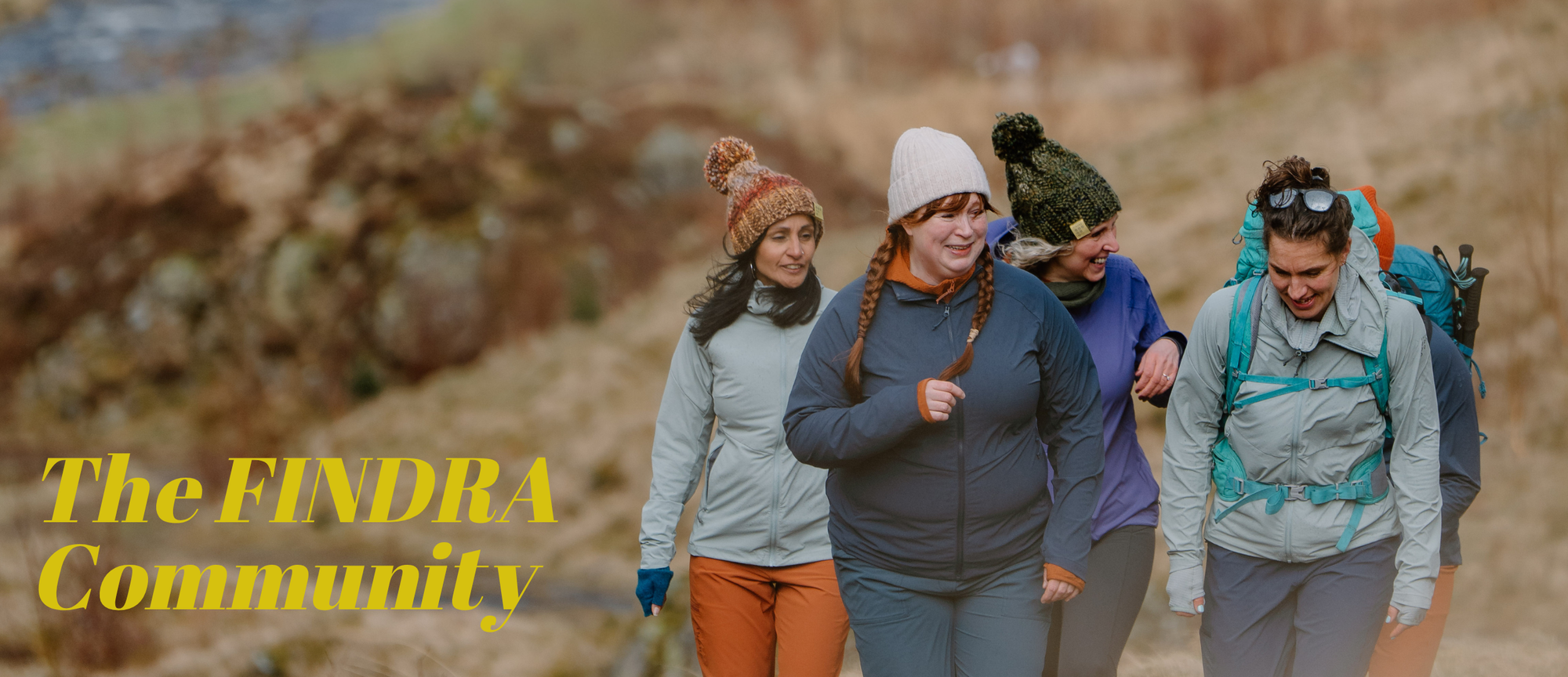 Four people hiking outdoors with 'The FINDRA Community' text overlay.