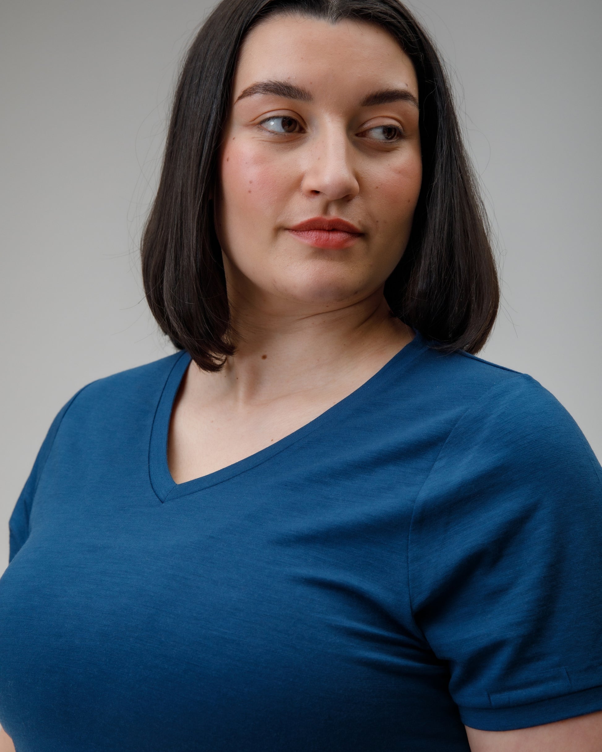 Woman wearing a blue shirt against a plain background
