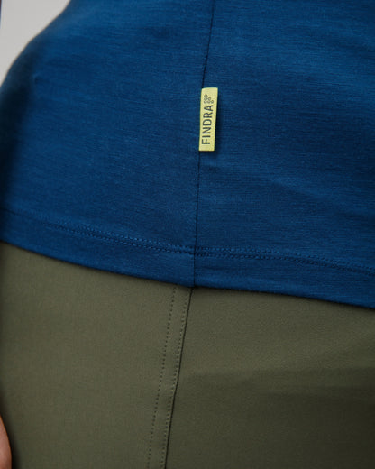 Close-up of a blue and green garment with a yellow findra brand label.