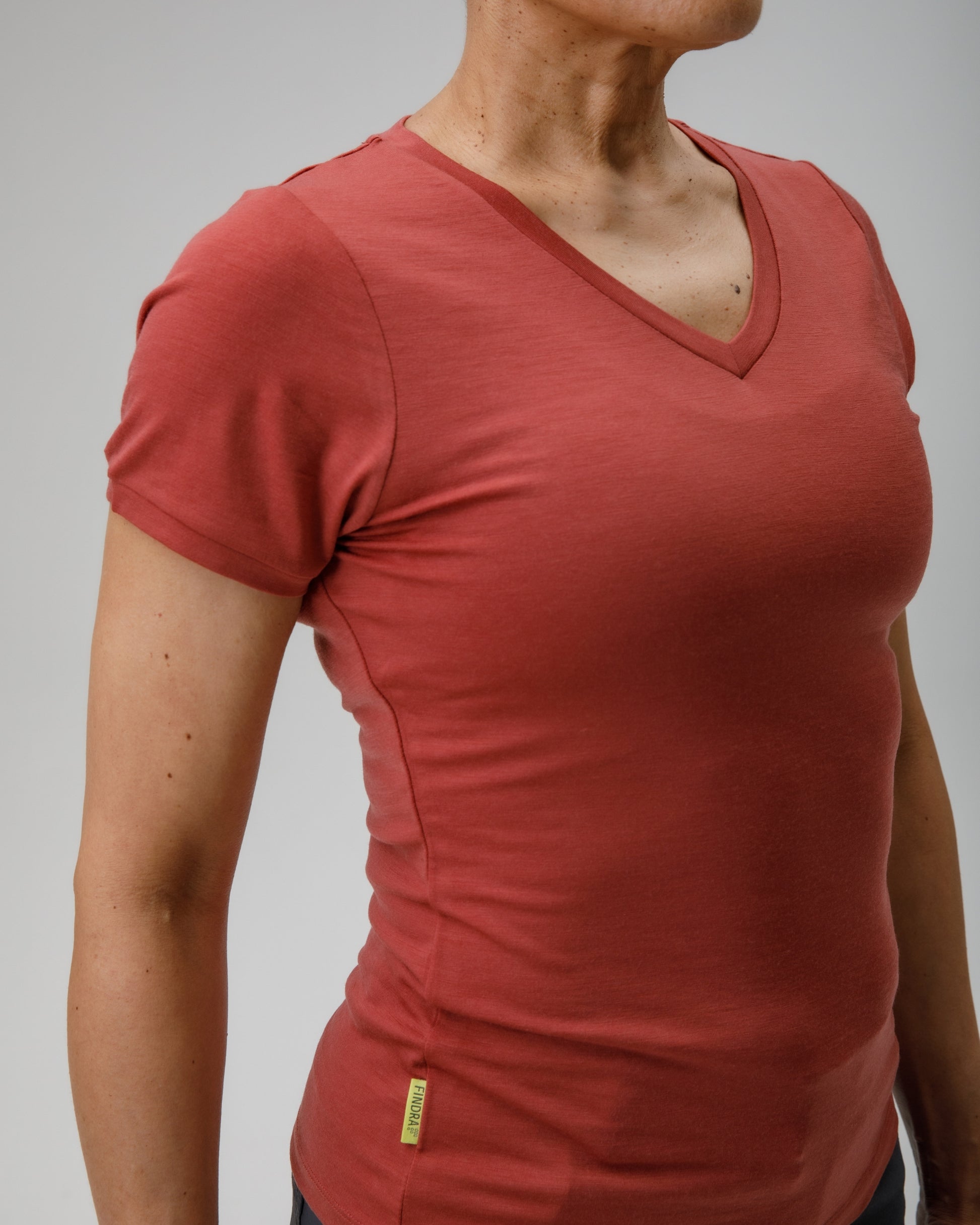 Person wearing a red t-shirt against a gray background