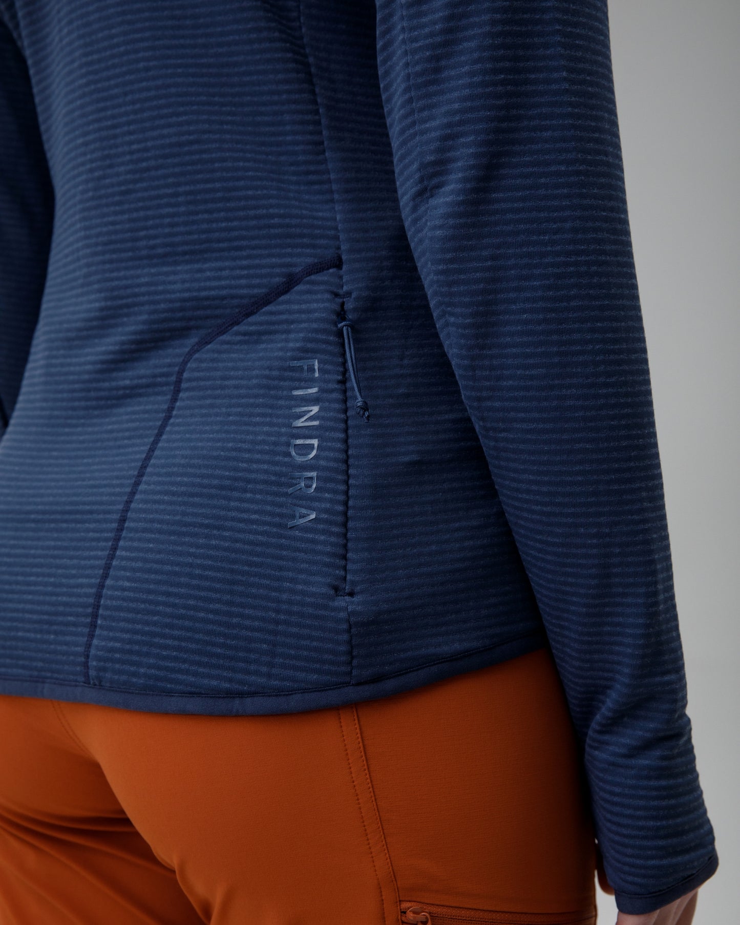 Blue jacket with a "FINDRA"  brand logo on a gray background