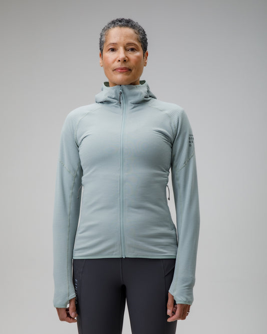 Person wearing a light blue jacket on a gray background