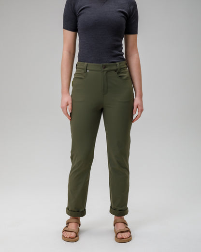 Person wearing green pants and a black top on a white background
