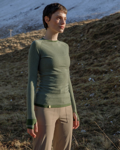 Woman in the outdoors wearing a FINDRA Striped Merino wool top and Millie technical trousers
