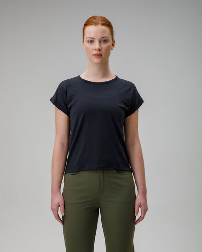 woman wearing a charcoal merino wool t-shirt on a grey background