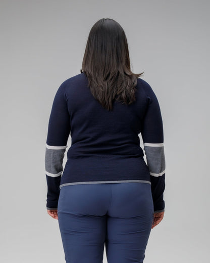 Person wearing a navy blue outfit with gray accents on a plain background