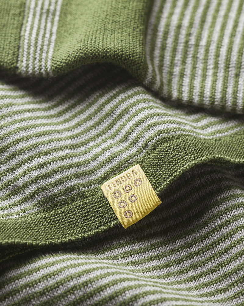 Close-up of  green and grey striped Merino wool with a yellow label featuring 'FINDRA' branding.